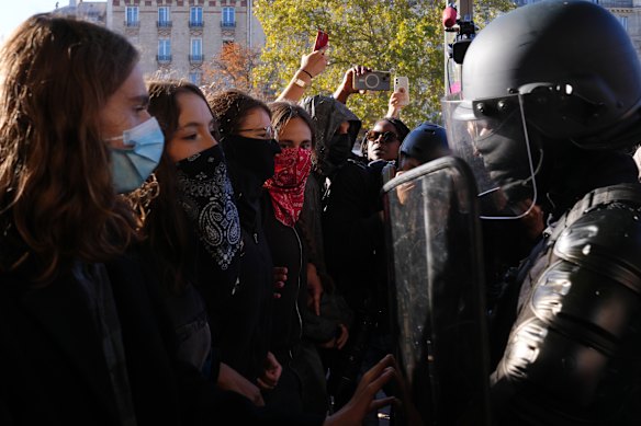 Students face police officers in front of the Helene Boucher high school.