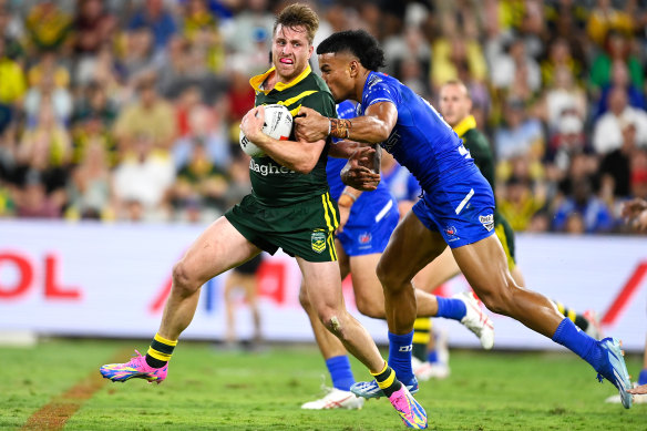 Cameron Munster tries to slip past Stephen Crichton.