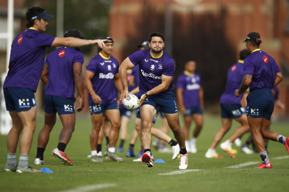 Brandon Smith looks to get the ball away during Melbourne Storm  training at Geelong Grammar on Friday.