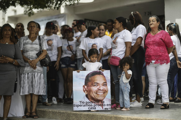 A girl holds a sign with the image of Luis Manuel Diaz, father of Colombian soccer star Luis Diaz.