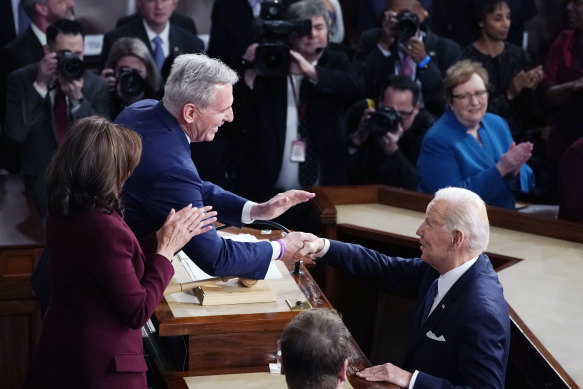 President Joe Biden arrives and shakes hands with House Speaker Kevin McCarthy before delivering his  2023 State of the Union address.