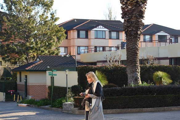 A resident in front of the apartment complex that has suffered damage.