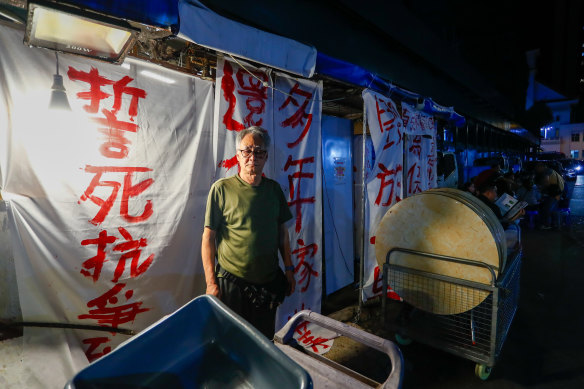 Banners outside Tsang Kam Por’s shop to protest against the government’s redevelopment plans.