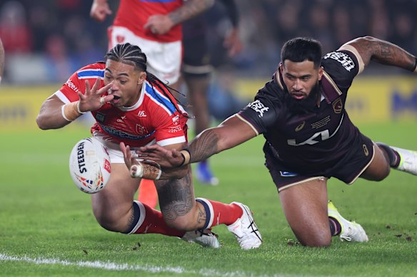 Hull KR's Tom Amone crosses the line to score in the World Club Challenge match between Hull KR and the Brisbane Broncos.