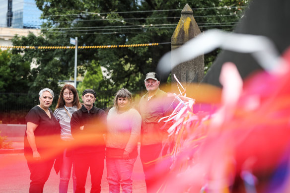 Jenni Di Trani, Jeanette Richardson John Lawrance, Helen Dawson and Brian Cherrie tie ribbons to the fence outside St Patrick’s Cathedral in Melbourne.