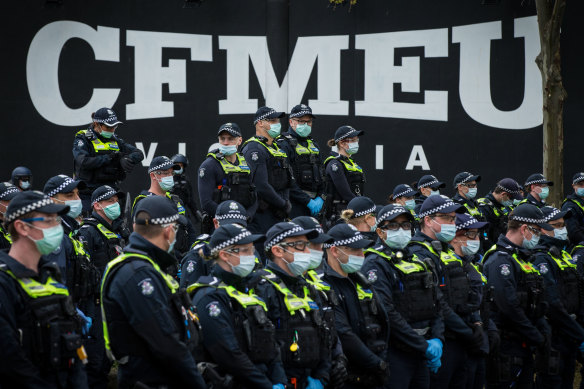 Police officers monitor a protest outside by construction workers outside Melbourne’s CFMEU office in 2021.