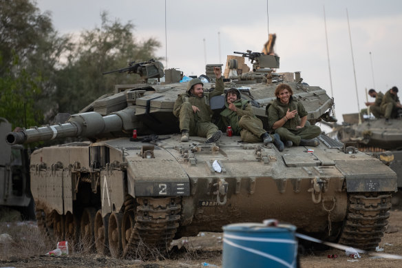 Israel Defence Forces reservists gather near the border with Gaza.