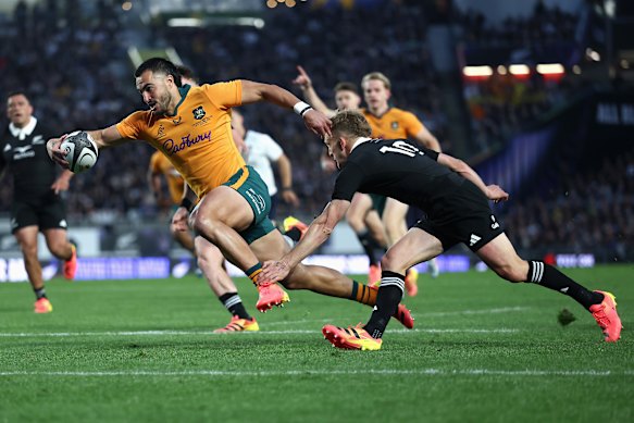 Tom Wright dives over for the opening try.