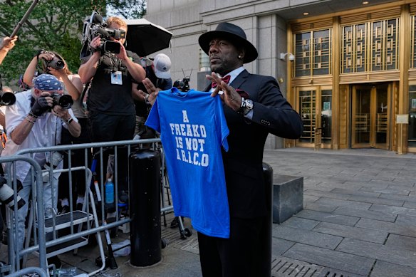 Charlie Liucci holds up a shirt in support of Sean “Diddy” Combs outside Manhattan federal court after Sean “Diddy” Combs was convicted of prostitution-related offenses but acquitted of sex trafficking and racketeering charges.