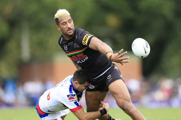Viliame Kikau offloads for Penrith against the Knights at Carrington Park.