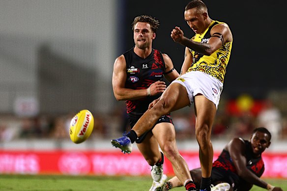Shai Bolton, right, kicks the ball. 