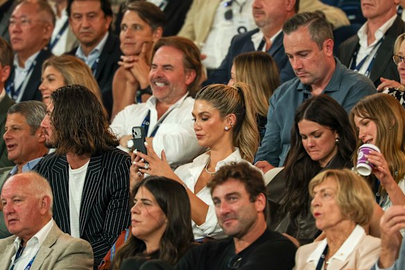 Delta Goodrem (middle) takes a picture at the Australian Open women’s final.