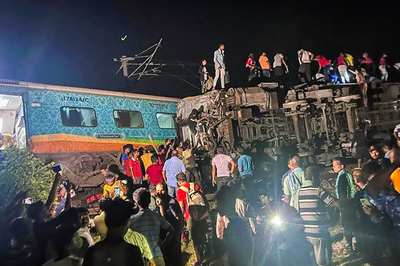 Rescuers work at the site of the derailment to free hundreds of trapped passengers. 