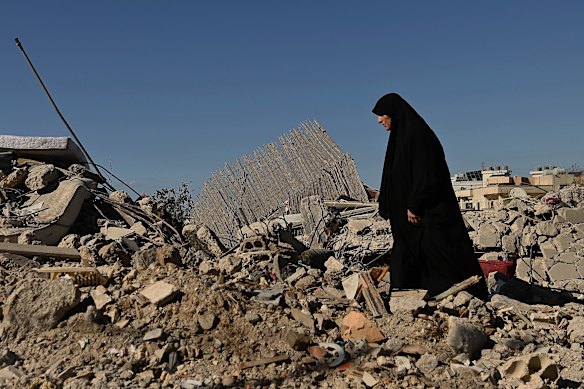 Um Qassem at the bomb site where authorities are still searching for her nephew following an Israeli airstrike on Ghaziyeh on March 8.