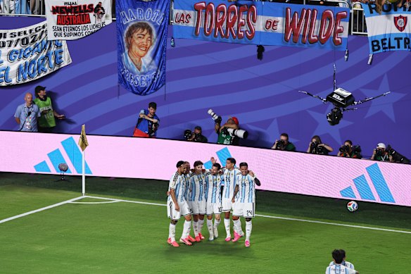 Messi and his teammates celebrate his second goal. 