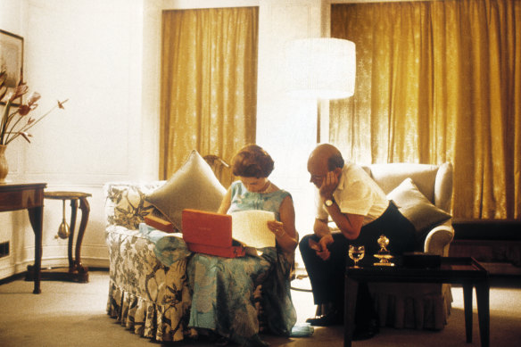 Queen Elizabeth and her private secretary Sir Martin Charteris reviewing papers late at night on the royal yacht Britannia in 1971.