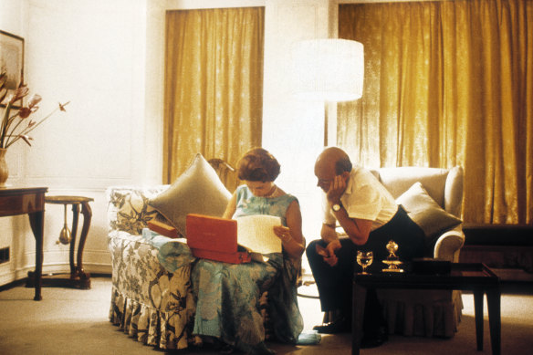 Queen Elizabeth and Sir Martin Charteris review papers on the royal yacht Britannia in 1971. 