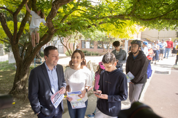 Liberal leader Matthew Guy and his family in the queue at Serpell Primary School in Templestowe on Saturday.