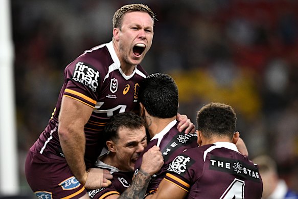 Brisbane Broncos celebrate scoring against the Bulldogs.