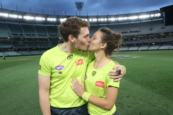 Umpires Dillon Lee and Eleni Glouftsis seal their engagement with a kiss.