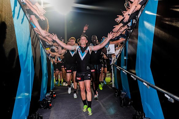 Zak Butters leads Port Adelaide off the ground after their stirring win over Geelong on Saturday.
