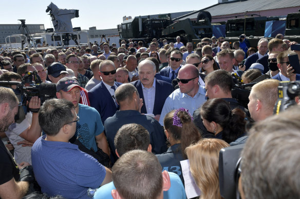 Workers heckle President Alexander Lukashenko, centre, as he visits the Minsk Wheel Tractor factory. Strikes spread across Belarus on Monday.