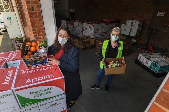 Grace Grieve (right) and Lisa McKenzie preparing food to be delivered to people in isolation. 