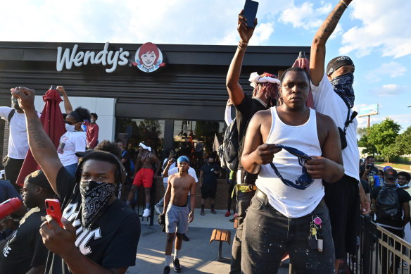 Protesters demonstrate outside a Wendy's restaurant in Atlanta where Rayshard Brooks, a black man, was shot and killed by Atlanta police on Friday evening following a struggle in the drive-thru line.