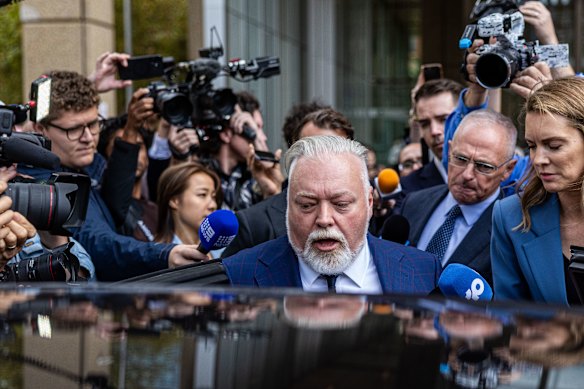 After a bruising hearing, Kyle Sandilands enters his Rolls-Royce, which has an estimated value of near $1 million.