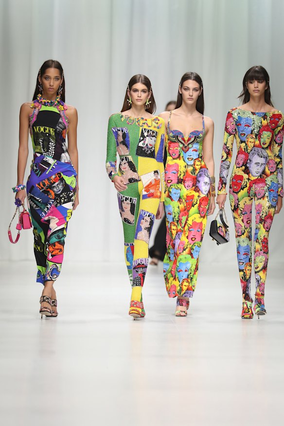 Models wear Versace’s Tribute Collection, printed with Vogue magazine covers and portraits of James Dean and Marilyn Monroe.