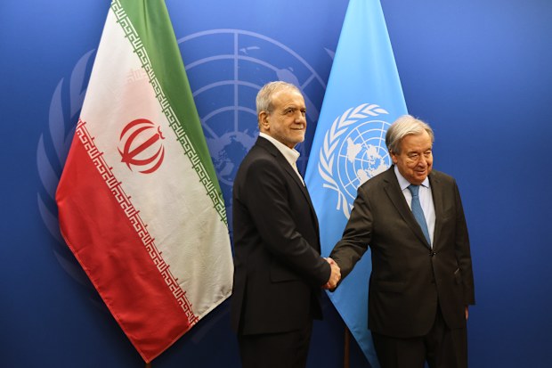 Iran’s President Masoud Pezeshkian, left, shakes hands with United Nations Secretary-General Antonio Guterres at United Nations headquarters