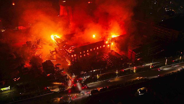 The Nepalese parliament burns after being set on fire by protesters.