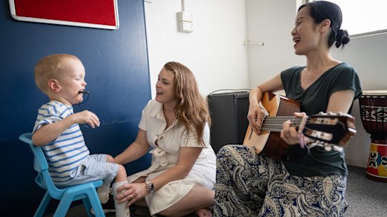 Gemma Ryan, with her son Max, and Winnie Choy, a registered music therapist, campaigned against the funding cuts.