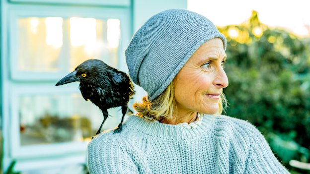 Sam Bloom with Frankie the currawong, one of the family’s current feathered friends.