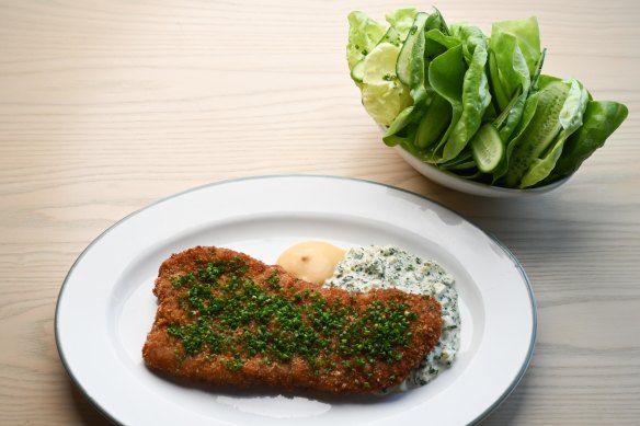 The veal schnitzel is served with two sauces: gribiche and mustard.