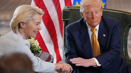 European Commission president Ursula von der Leyen and US President Donald Trump shake hands on a new deal.  