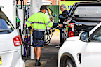 Long queues for petrol at a Sydney service station.