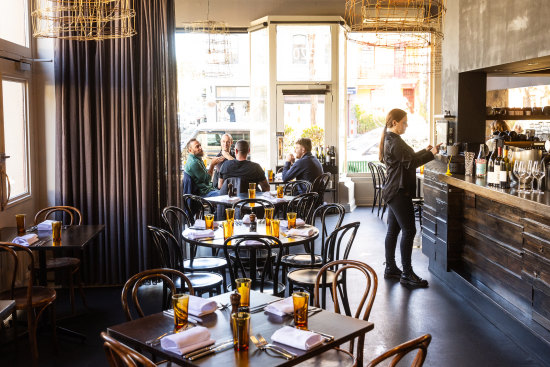 Dark walls and light fixtures made from fencing wire create a masculine aesthetic at La Luna.