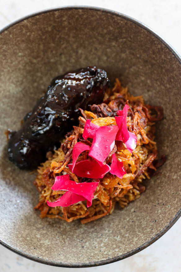 Lamb collar, carob molasses, mujaddara, rose petals.   
