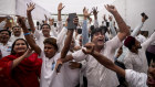 Congress party supporters cheer as votes are counted at their party headquarters in New Delhi, India, on Tuesday.