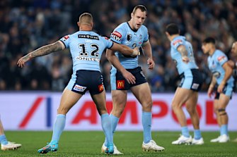 Isaah Yeo of the Blues stumbles after being hit while making the opening tackle.