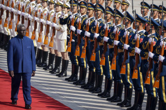 Solomon Islands Prime Minister Manasseh Sogavare reviews a Chinese honor guard during a welcome ceremony at the Great Hall of the People in Beijing, China. 