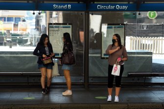 Passengers wait for a bus at Circular Quay on Monday.