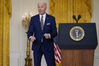 US President Joe Biden jokes about doing push-ups during a news conference in the East Room.