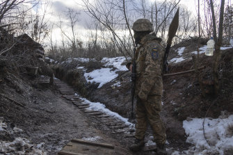 A Ukrainian marine walks in a trench at the line of separation from pro-Russian rebels in the Donetsk region, Ukraine.