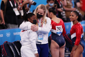 Simone Biles is comforted by coach Cecile Landi.