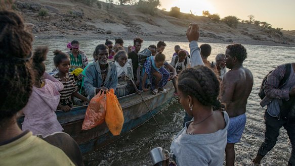 Tigray refugees arrive on the banks of the Tekeze River on the Sudan-Ethiopia border, in Hamdayet.