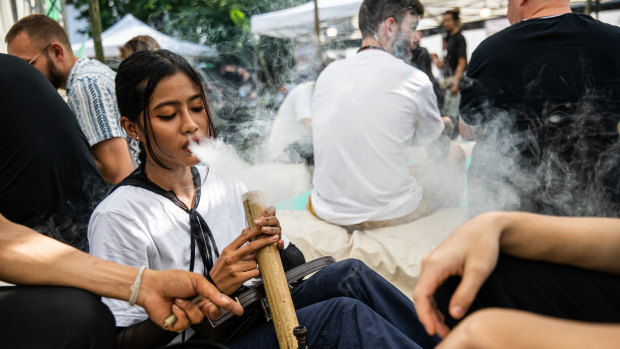 People smoke marijuana at the Thai High Convention in Chiang Mai in December.