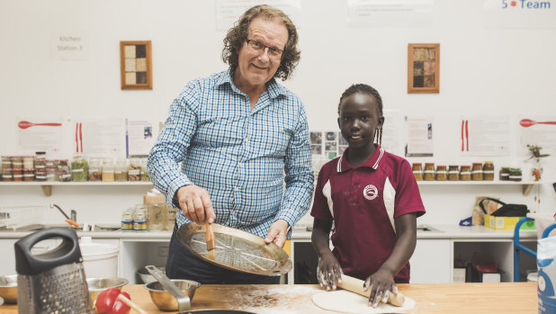 Teacher Peter Curtis and student Aman Jok Nhial 9, make a pizza.
