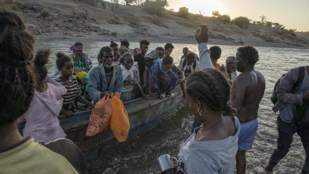 Tigray refugees arrive on the banks of the Tekeze River on the Sudan-Ethiopia border, in Hamdayet.